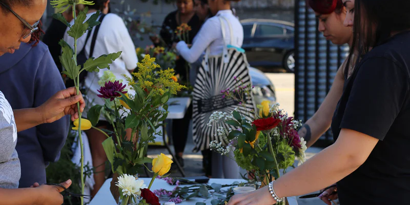 Floral students selecting flowers from a  table