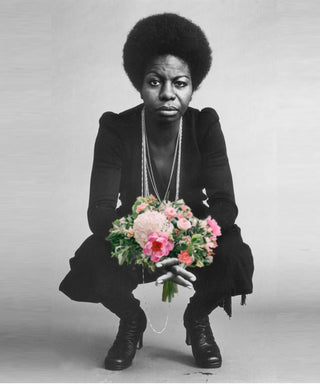 Nina Simone holding flowers.