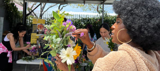 Black woman holding a flower bouquet