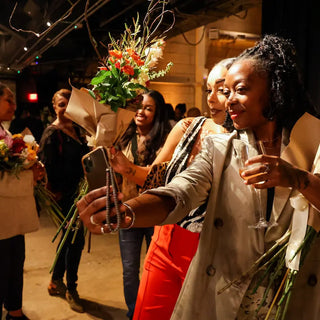 Two woman taking a selfie in an interactive flower station