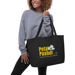 Woman holding a Petal Pusher Postal Petal tote